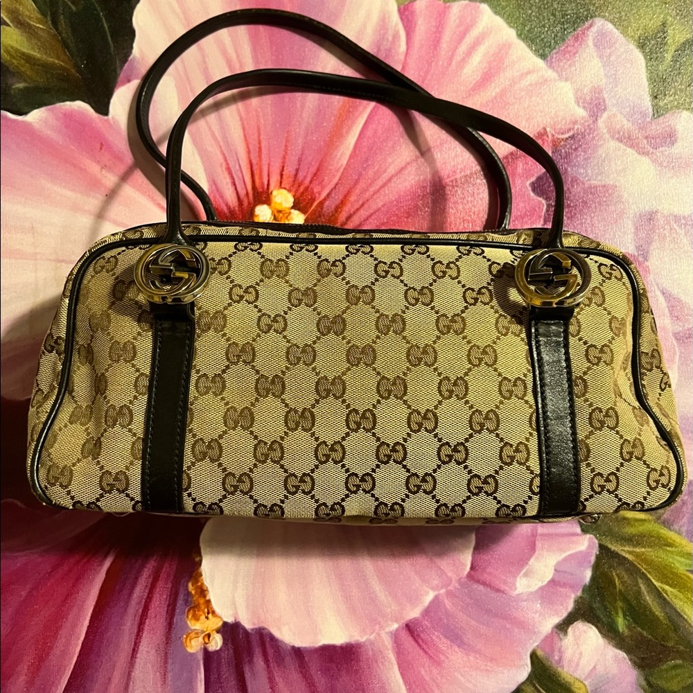 Pre loved Gucci handbag. Silver and gold Gucci on all sides.